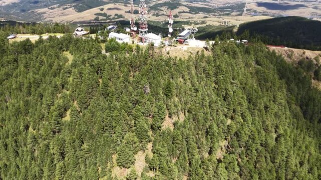 Zlatibor, Serbia. Flying Above Tornik Summit, Communication Towers, Gondola and Ski Lift Stations, Green Pine Forest