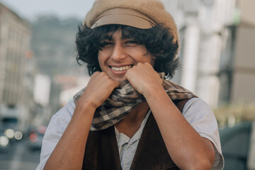 young fashion man holds his scarf