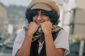 young fashion man holds his scarf