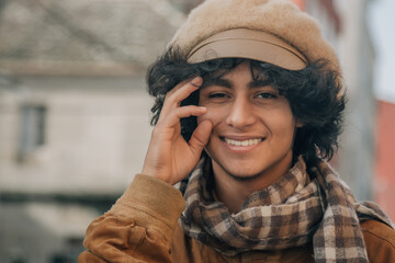 portrait of a casual smiling young man wearing autumn clothes