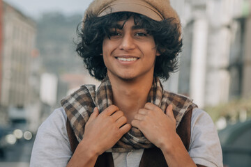 young fashion man holds his scarf