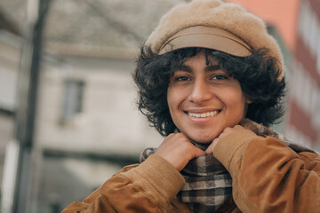 young fashion man holds his scarf