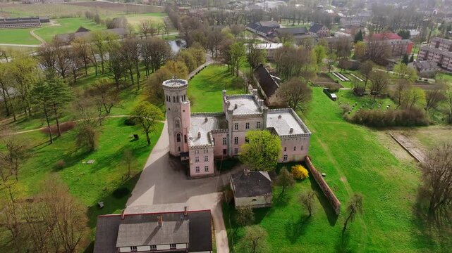 Cinematic drone orbit showing Vecauce Palace, Dobele region during sunny spring