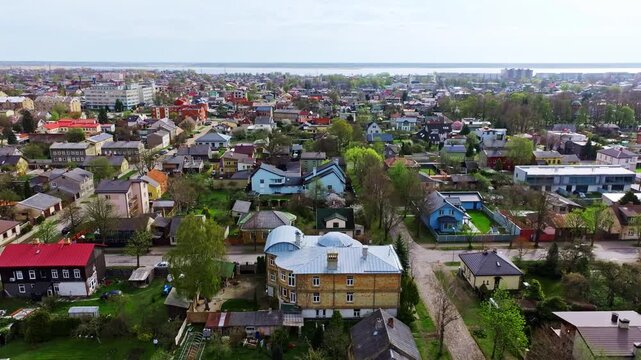 Cityscape scene from above showing coastal district of Liepaja, vivid rooftops