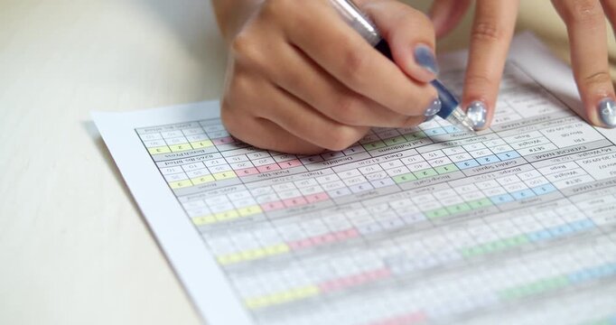 Hands meticulously filling out a chart capturing essence of data recording in a professional environment.