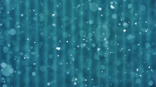 Minimal abstract shot of snow falling over lined blue metal background, daylight