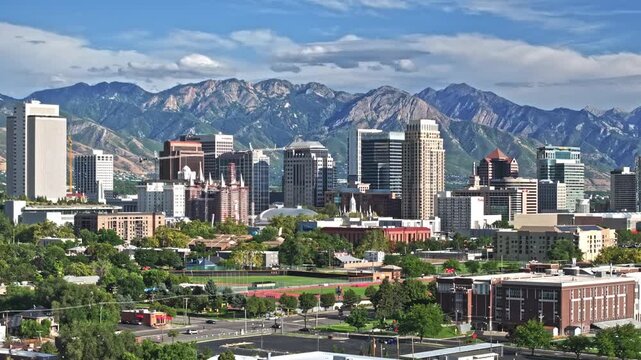 Aerial Shot over streets from Salt Lake City and Wasatch Mountains in the background