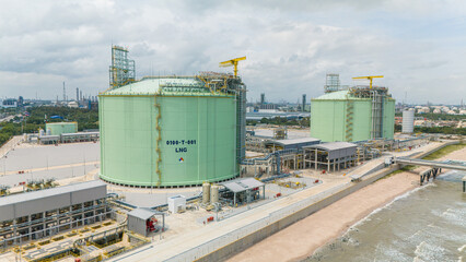 Obraz premium Natural gas storage. LPG tank at sea shore. large LNG or liquefied propane tank at ocean seaside.