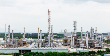 Fototapeta premium Refinery Building. Oil and Gas Power Energy Industrial. Petrochemical Plant Tower, Storage Tank And Pipeline.