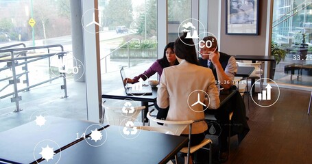 Discussing three professionals analyzing data overlays in cafe lounge, with laptop and eco icons