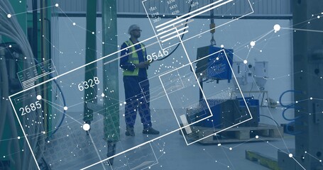 Factory tech in helmet and vest examining component hanging from crane hook, with data overlays