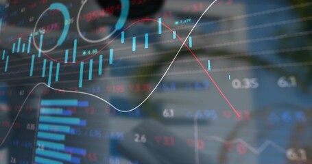 Displaying translucent candlestick and line graphs over wooden desk, with smartphone and laptop pen