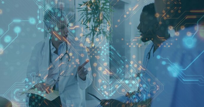 Doctors discussing patient data in hospital corridor, with tablet, clipboard and circuit overlay