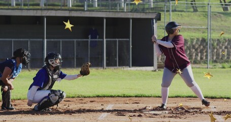 Standing maroon jersey batter holding bat in dirt infield, with catcher and gold stars, copy space