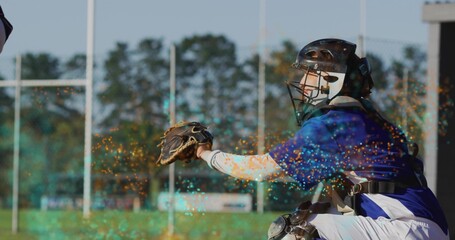 Crouching female baseball catcher wearing helmet mask, extending mitt at home plate, sparkles