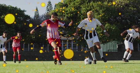 Dribbling black-and-white kit player evading red-and-white opponent on grass pitch with soccer ball