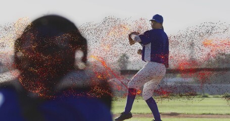 Winding up pitcher wearing blue cap throwing baseball on mound, catcher with helmet, mitt