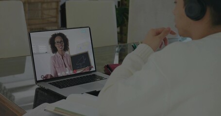 Attending geometry lesson on laptop, Korean teen boy wearing headphones at glass table, copy space