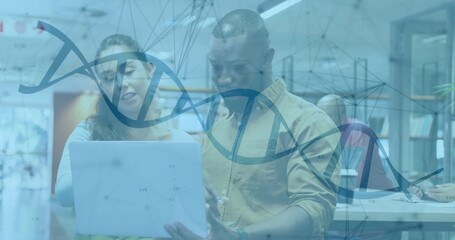 White woman and African American man reviewing graphs on laptop in lab, with DNA helix overlay