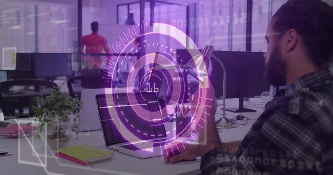 Holding smartphone, developer coding on laptop in modern office with digital overlay, copy space