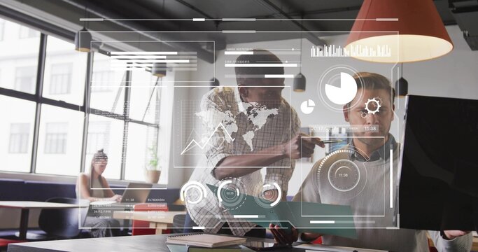 Pointing data analyst and colleague reviewing holographic map data in office space, with laptop
