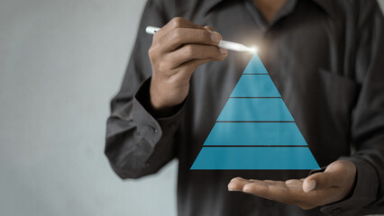 Business strategy and management hierarchy pyramid, businessman drawing digital pyramid chart with...