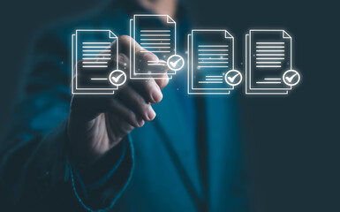 Businessman selecting digital documents with check marks on virtual screen, representing data approval, document management, technology, efficiency, and business success concept.