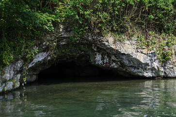 Cave entrance at water level.