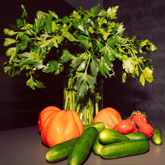 Vegetables and fresh parsley styled on kitchen surface, photographed in dramatic lighting with strong contrast and shadow play, creating expressive modern food composition