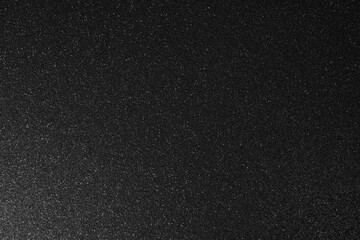 Dark glitter background with industrial metallic feel, gradient light enhances relief while subtle sparkles shimmer across moody abstract depth
