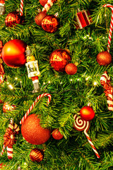 Christmas tree green holiday background. New Year fir tree close up with decor, branches, toys,...