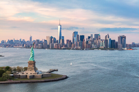 Aerial view of Manhattan skyline and Statue of Liberty at sunset, New York, USA