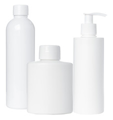 grouping of three plain, unmarked white plastic cosmetic bottles with caps and a pump dispenser, isolated on a pure transparent background for branding mockups.