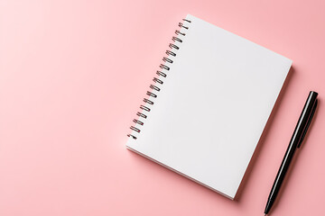A crisp white notebook with a spiral binding, paired with a sleek black pen, sits against a soft pink backdrop, inviting ideas and creativity. #stationery