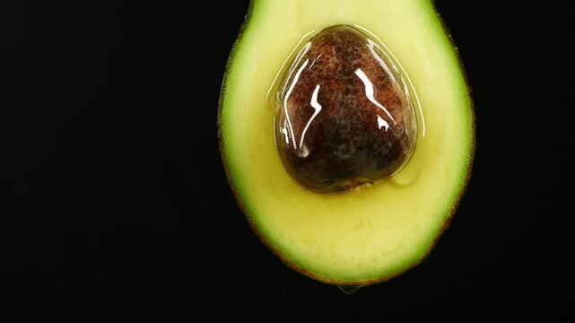 guacamole. Healthy food concept. close-up of fresh avocado fruit and oil flowing over black background healthy vegetarian delicious Breakfast Toas