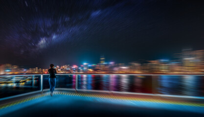 Hong Kong's night scene, captured with a radial blur, creates an abstract vision. The individual...