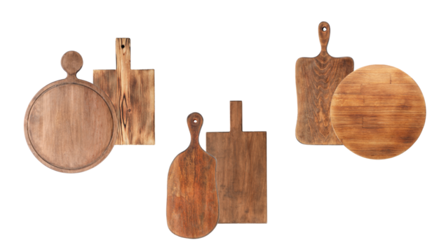photograph of three rustic wooden cutting and serving boards arranged together, featuring natural textures, burn marks, and rich tones, including paddle and round shapes, isolated on black.