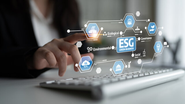 A business professional interacts with a digital interface displaying ESG concepts, emphasizing the importance of sustainable practices in modern corporate governance. Tessel - Powered by Adobe