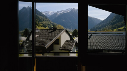 Mountain view from a cozy window overlooking Grossglockner during a bright sunny day