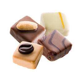 assortment of four luxurious gourmet chocolate pralines and truffles, featuring diverse coatings and toppings, elegantly isolated on a transparent background.