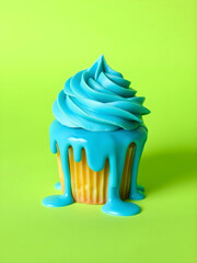 Vibrant Cupcake with Bright Blue Icing Drips on a Neon Lime Green Background