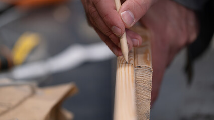 Obraz premium Real life woodworking with marking pencil on wooden plank