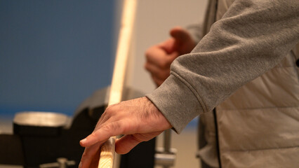 Hand checking wooden plank in workshop carpentry project
