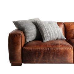 Cozy brown leather couch features soft pillows, perfect for relaxing in a stylish living room environment