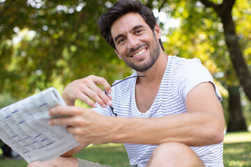 businessman reading the newspaper in the park
