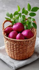 Close up of fresh purple sweet potatoes glistening with water droplets nestled in a rustic woven basket adorned with vibrant green leaves on a textured grey background studio lighting