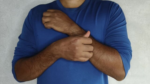 Asian or indian adult person hand scratch itching sensitive arm skin. Dust allergy, eczema, mosquito bite, insect bite, food allergic reaction, dermatology problem, rash and fungal disease concept.