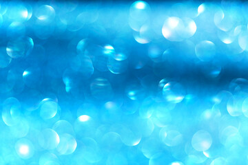 Blue bokeh background with soft glowing circles of light creating a cool, dreamy, and tranquil effect. The abstract blur perfect for modern designs, wellness concepts, or winter-themed visuals.