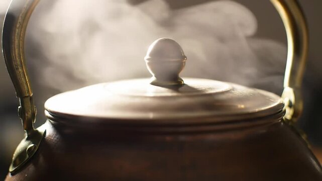 Close-up shot of a steaming copper kettle, creating a cozy and warm atmosphere