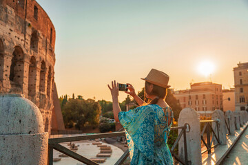 08 08 2025 Rome, Italy - Traveler photographing Colosseum during sunset